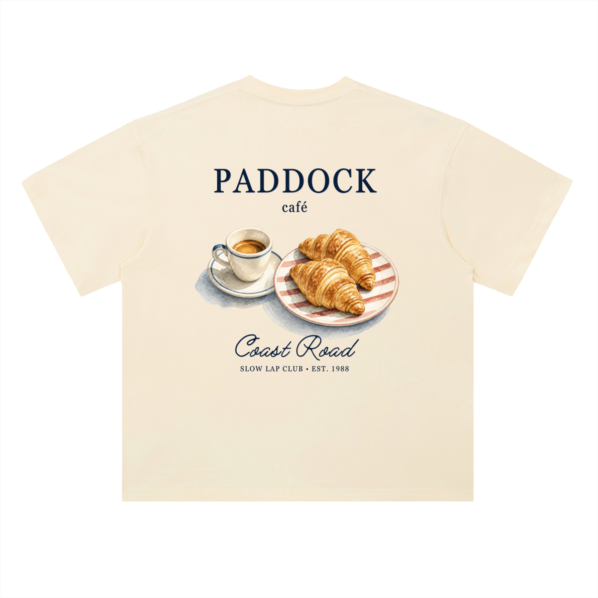 Paddock Café Racing Graphic T-Shirt in Milk Apricot, a relaxed-fit motorsport streetwear tee, back view: espresso and croissants under Paddock Café lettering