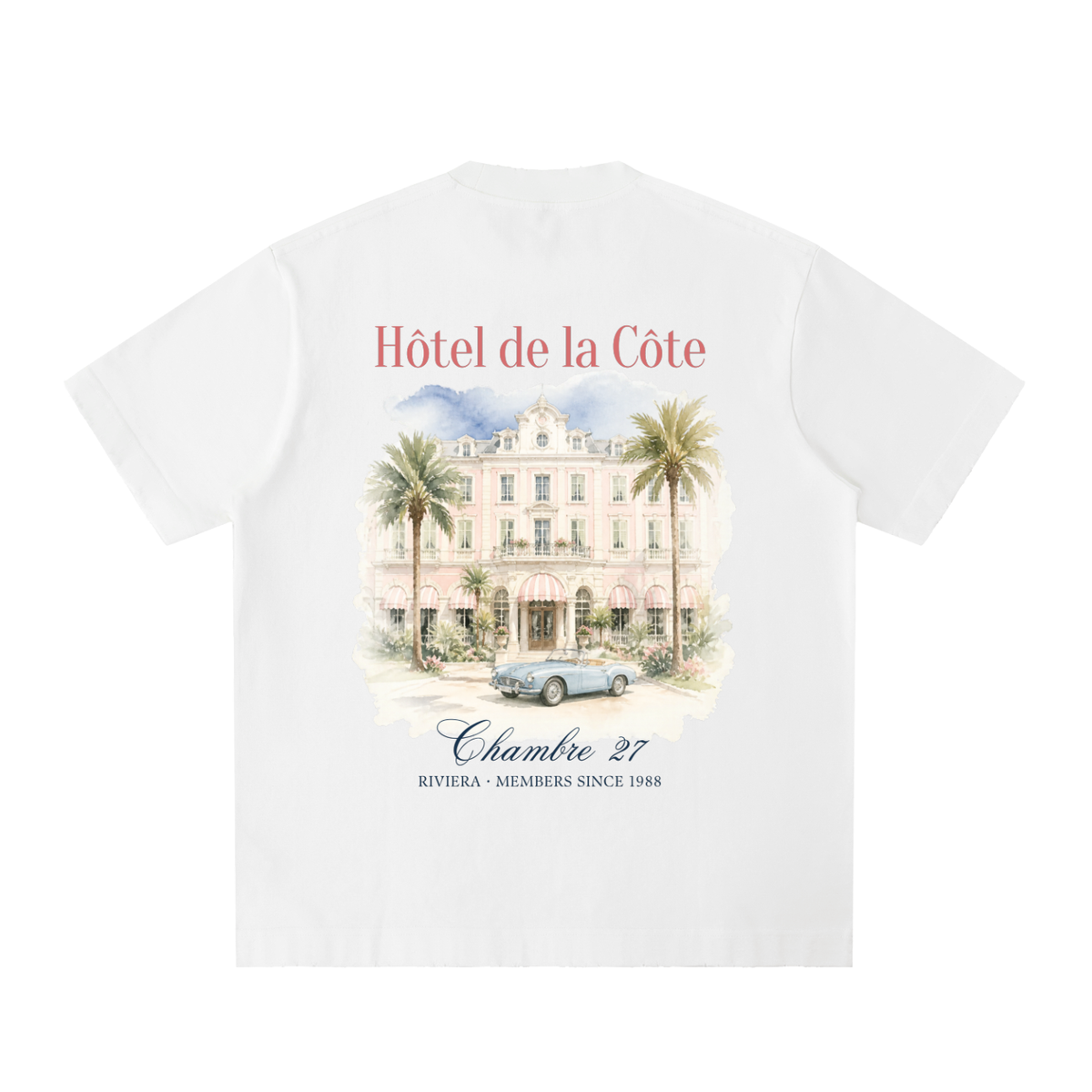 Hôtel de la Côte Washed Racing T-Shirt in White, a relaxed-fit vintage car tee, back view: watercolor Hôtel de la Côte facade with palms and a convertible