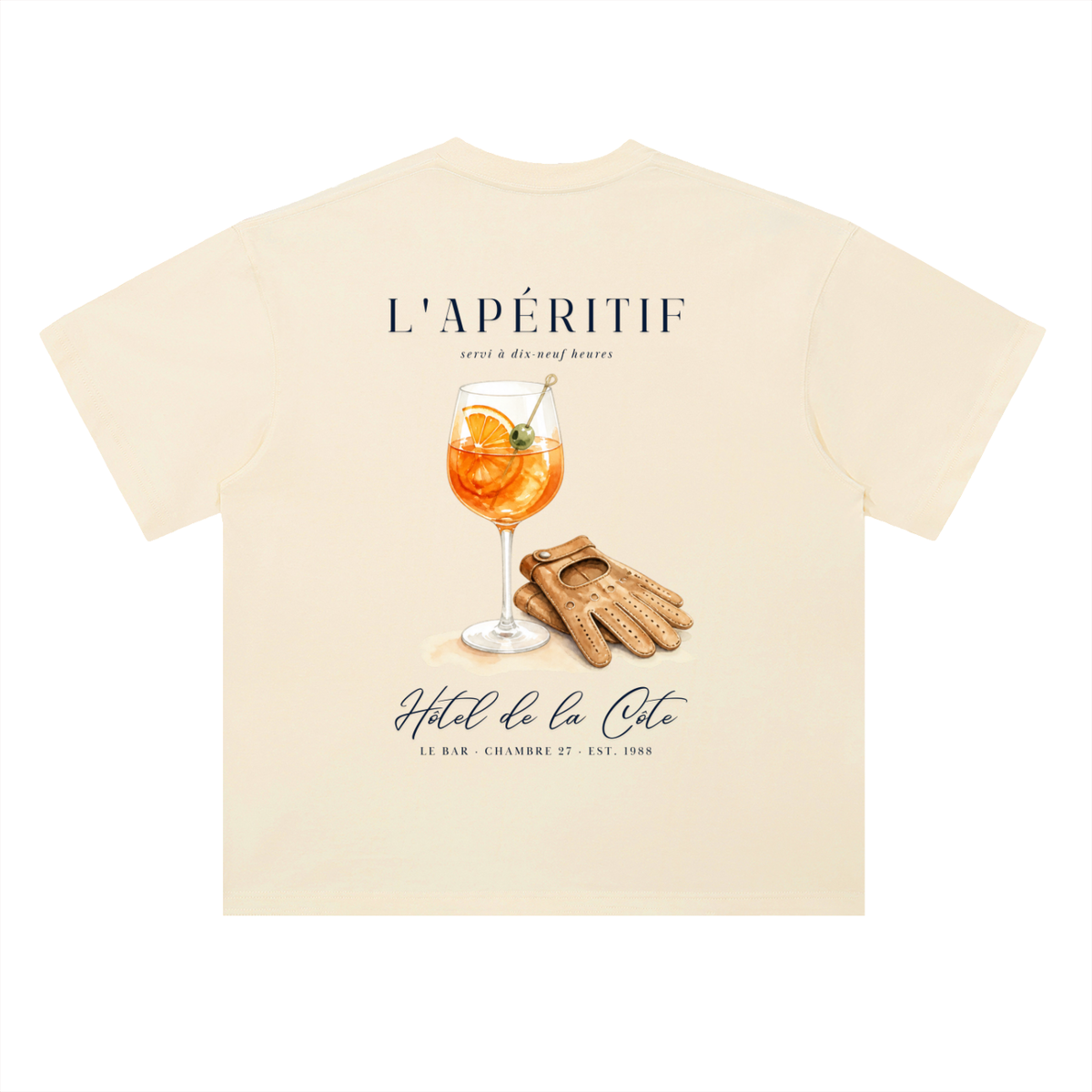 L’Apéritif French Riviera T-Shirt in Milk Apricot, a relaxed-fit tee for car and racing fans, back view: orange spritz and driving gloves under L’Apéritif lettering